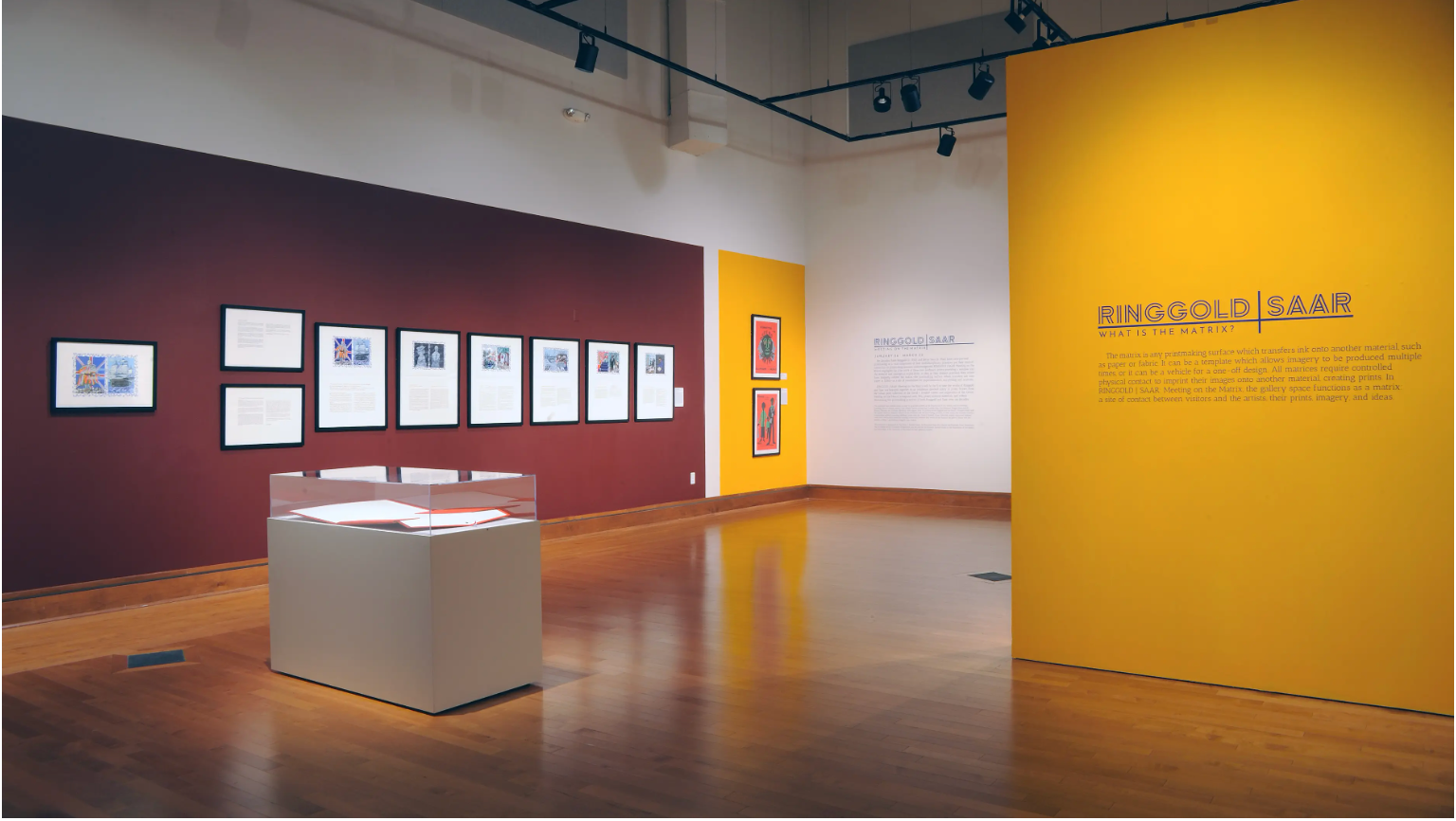 A photo of an art gallery with exhibits off in the distance on the walls