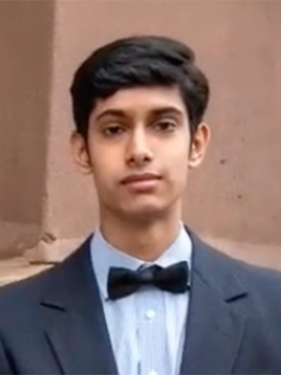 Srikar poses for a headshot in a black and white tux.