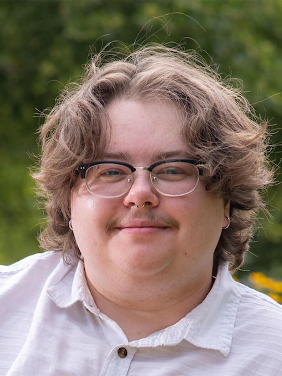 headshot of student wearing glasses and a white collard shirt