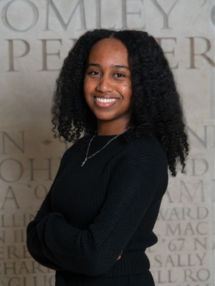 Headshot of student with long black hair wearing a black top