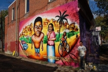 Picture of mural on a brick wall depicting a Hispanic family 