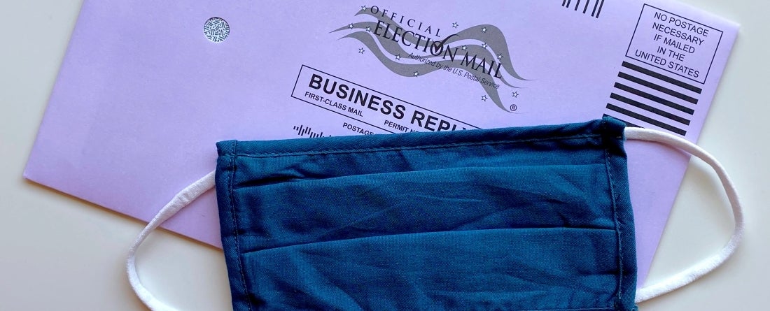 Image of mail-in election ballot and face mask