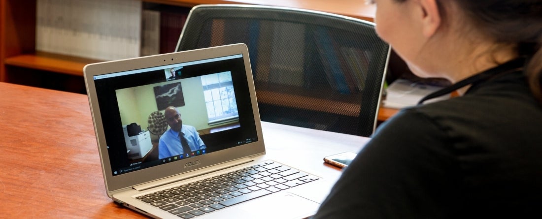 A girl on a virtual zoom meeting. 
