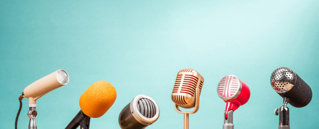 A row of different colored and sized microphones