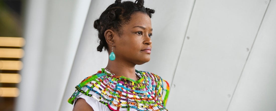 Aisha Washington looks confidently ahead, to the right