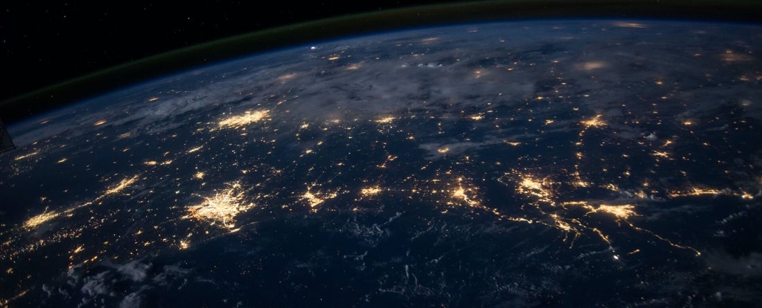 Earth as seen from space with cities glowing brightly