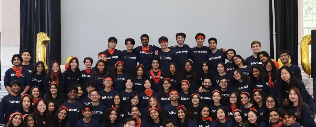 Students wearing matching navy Bit Camp shirts pose for a group photo
