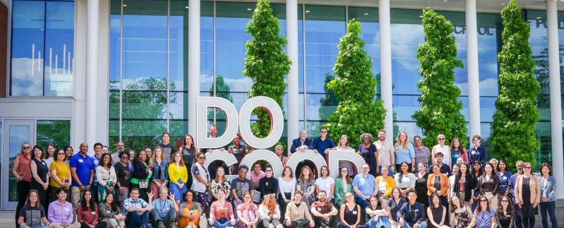 Do Good Campus Fund Year Two group in front of the Do Good Lighted Sign