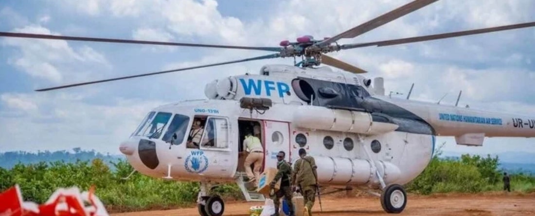 Image of World Food Programme helicopter being loaded with supplies and people; Photo credit: WFP/Michael Castofas.