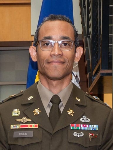 a man with glasses in a decorated army uniform